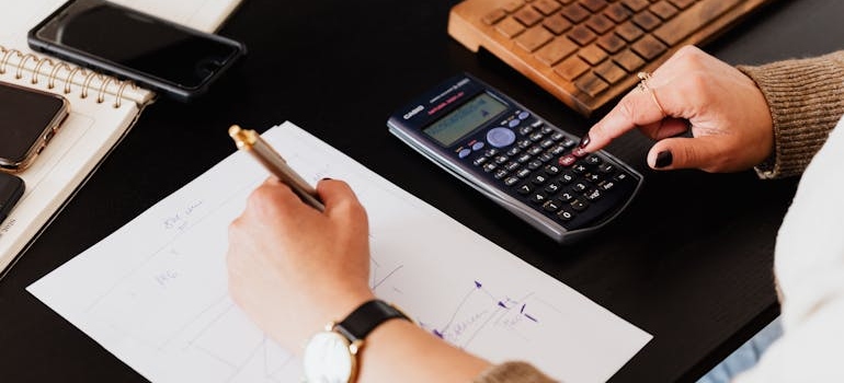 a person calculating What do most movers charge per hour