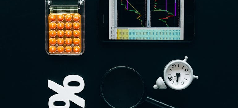 a calculator, percent sign, magnifier glass, and a graph