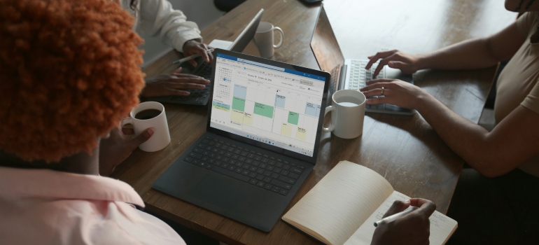 employees discussing how to manage inventory in Excel