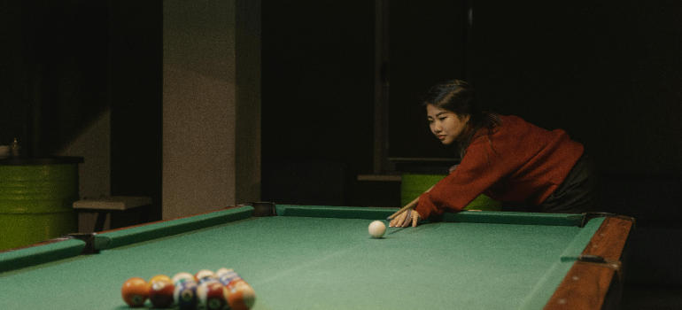 a woman playing billiards