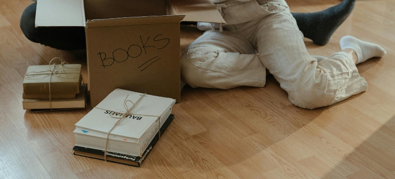 A close-up of packed books tied with twine, ready for relocation.