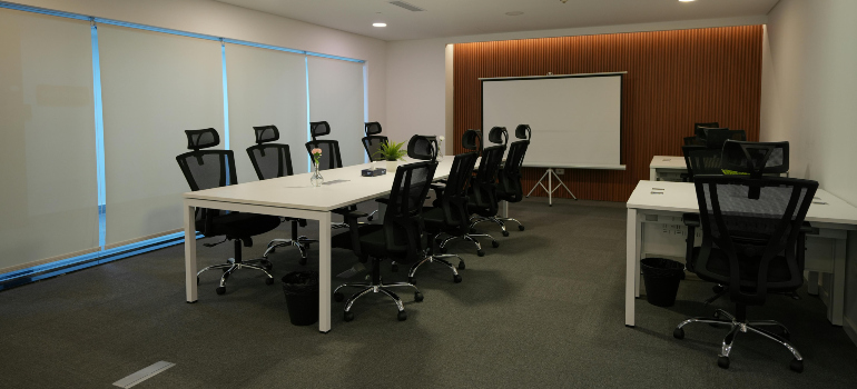 tables and chairs in an office, illustrating the additional things to consider when moving across the country 