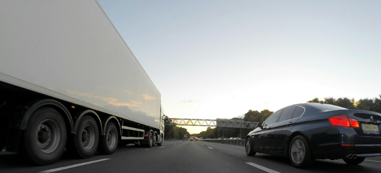 truck and car on road 