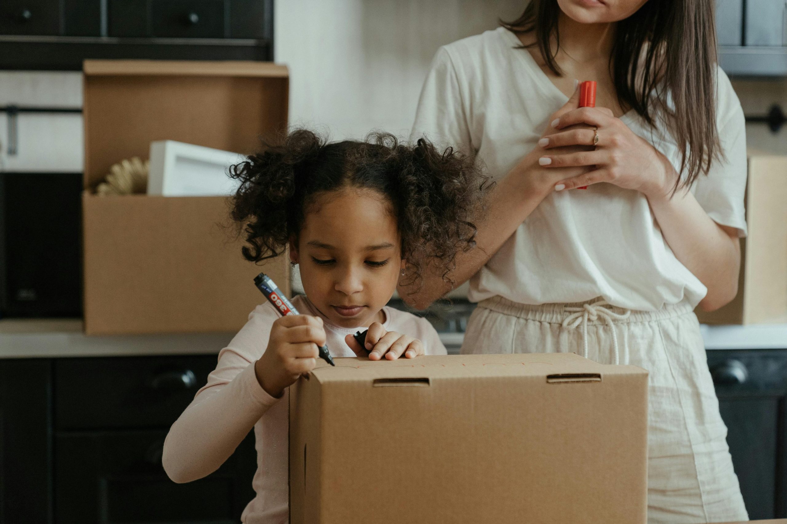 A little girl helping her family pack.