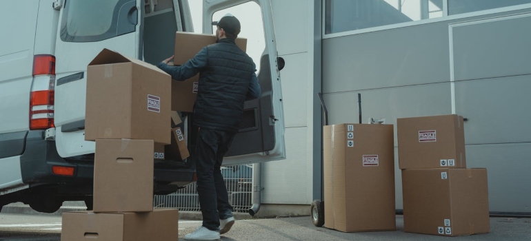 Person loading boxes into a van 