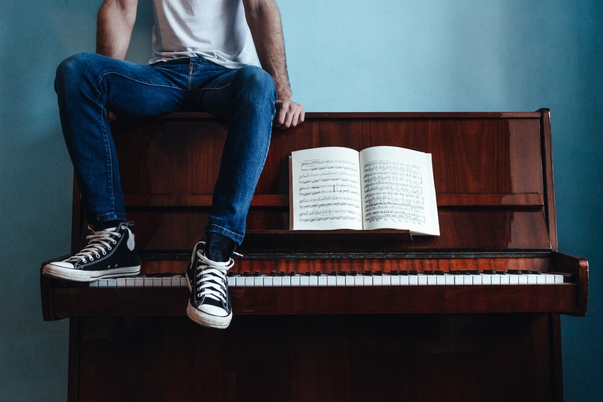 a man sitting on a piano