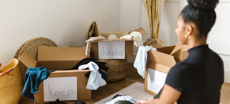 a woman decluttering and thinking about using junk removal services