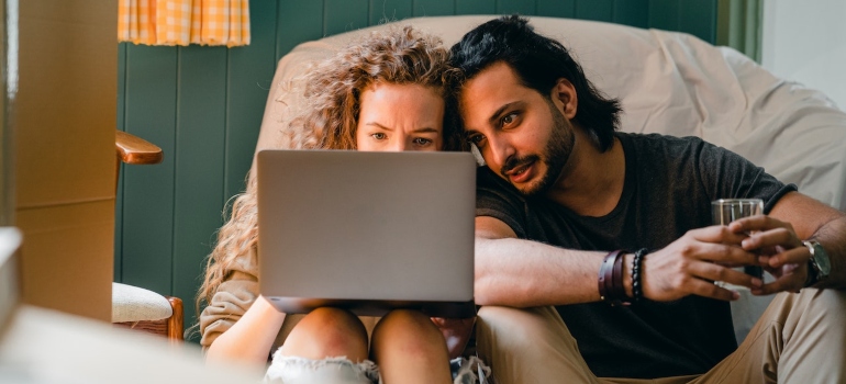 a couple browsing the net for the best Georgia destinations for young adults. 