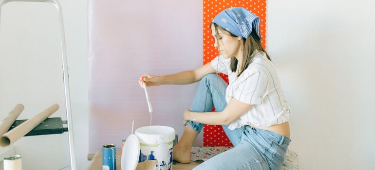 a woman painting the wall