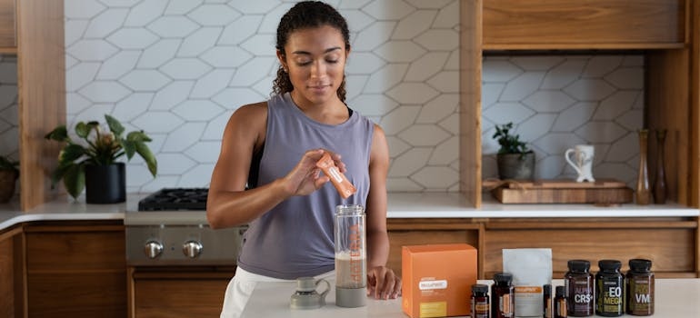 a woman making a protein shake 
