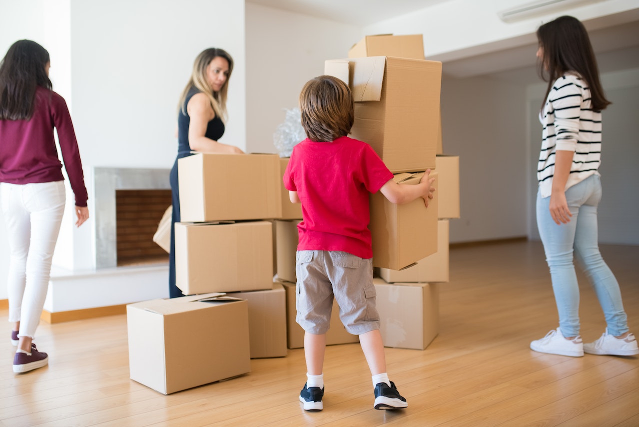 a family dealing with moving boxes