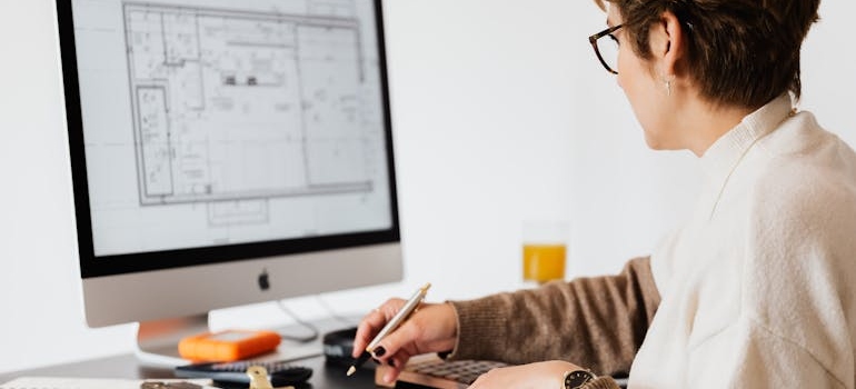 a woman looking at a floor plan