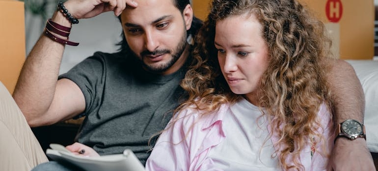 a couple making a checklist before hiring movers for two hours