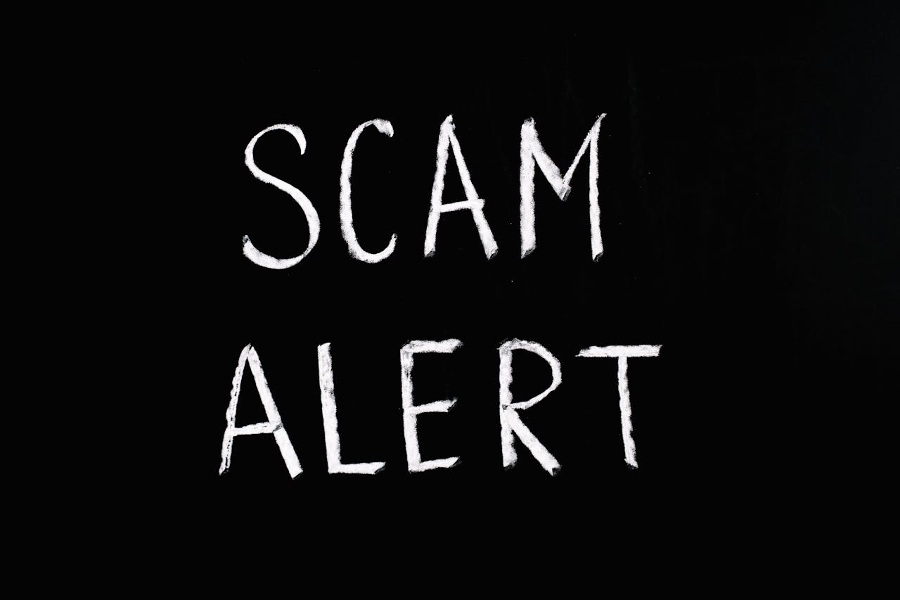 scam alert written on a black background