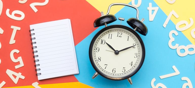 alarm clock and a notebook