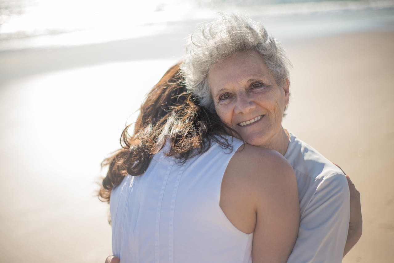 a mother hugging her daughter