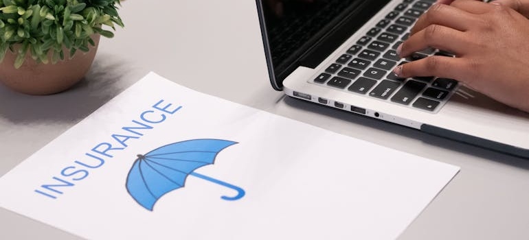 moving insurance and umbrella on a paper