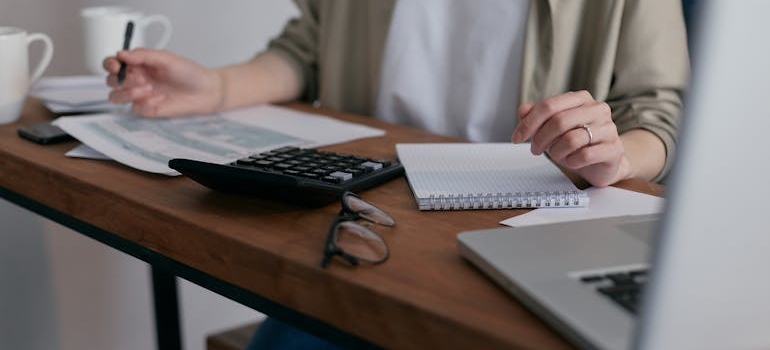 a person calculating the cost of the relocation trying to recognize moving frauds
