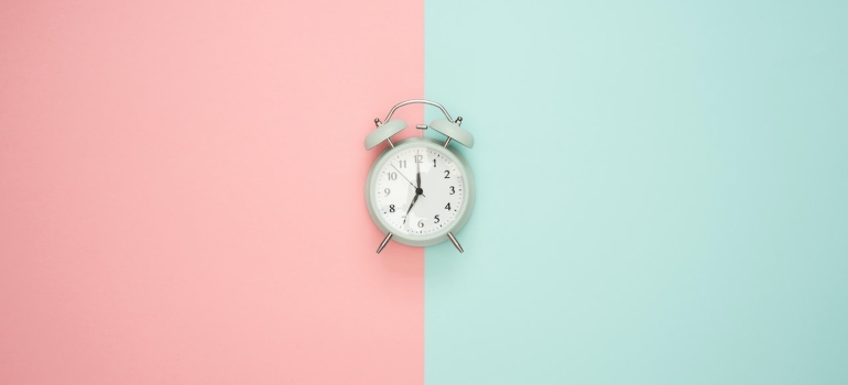 a clock on a pink and blue background