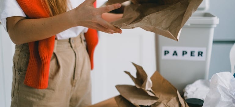 a person holding packing paper about to recycle packing materials in Georgia