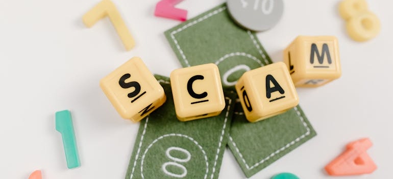 cubes with letters forming the word scams