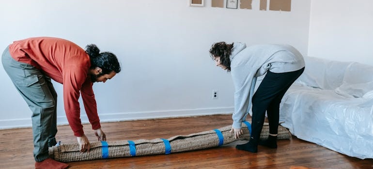a couple placing a rug 