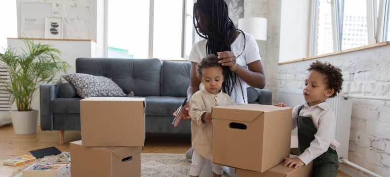 a mother packing with kids before moving to Atlanta