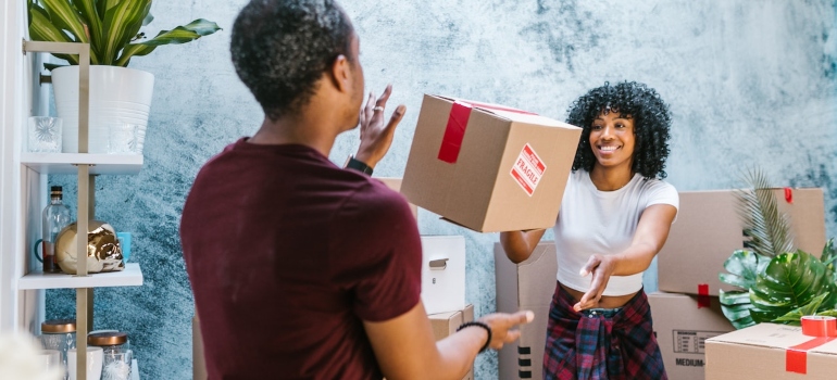 two people throwing a box to each other