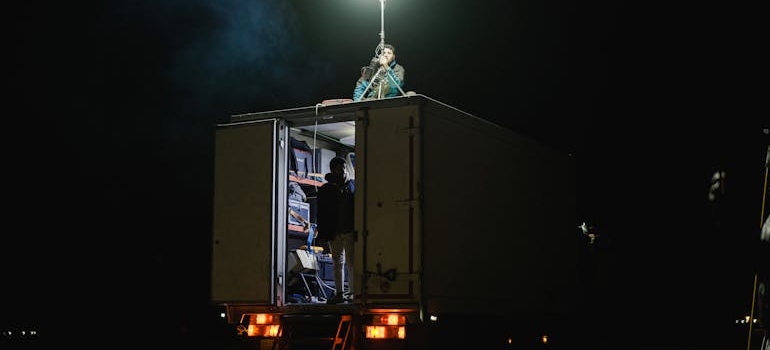 a person in a truck relocating movie equipment