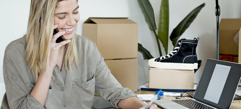 a woman making a call to compare costs and reduce commercial moving expenses
