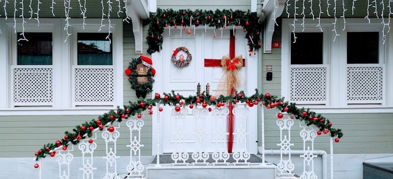 A white house with red and green decorations
