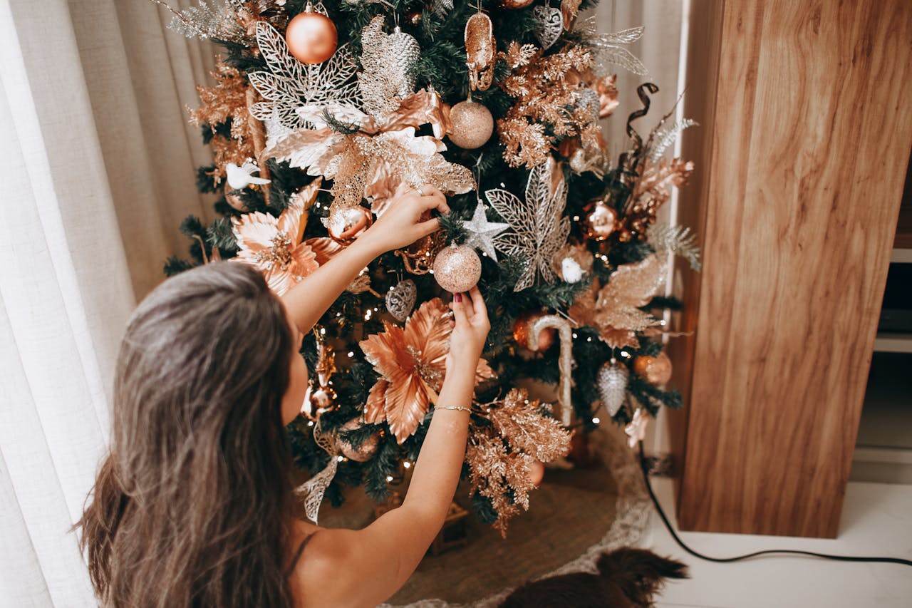 a woman decorating Christmas tree